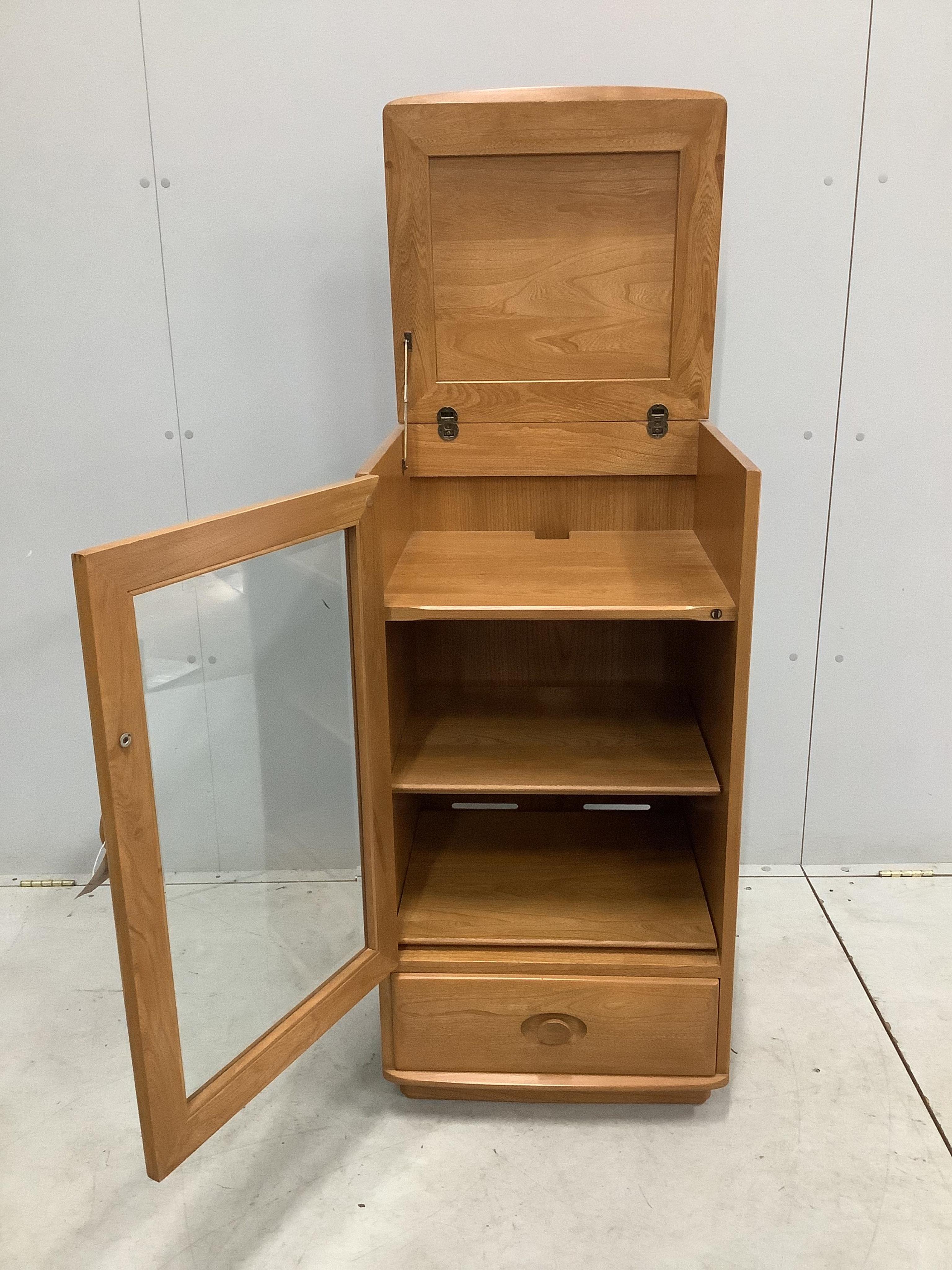 An Ercol Windsor elm Hi-Fi unit, width 50cm, depth 47cm, height 98cm. Condition - good